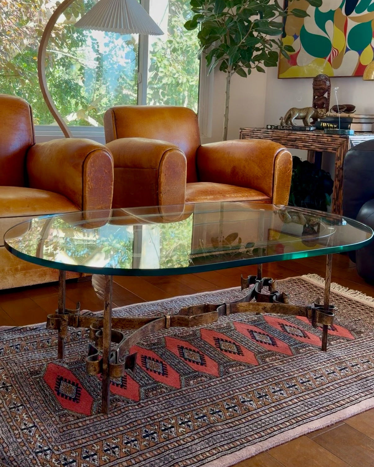 Scrolled gilt iron and glass coffee table, Italian, circa 1960s, with beveled oval glass top