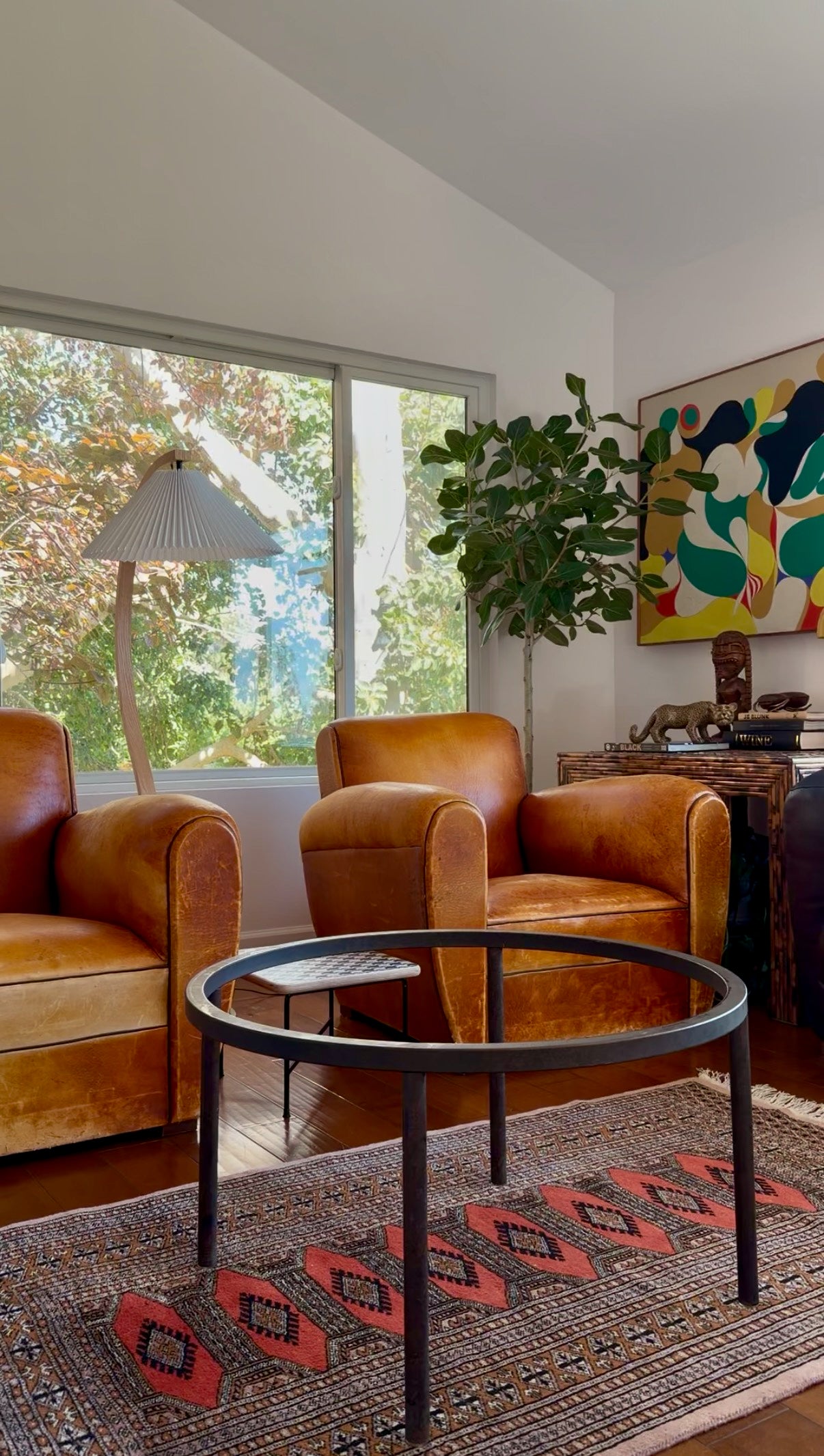Round studio glass coffee table on slim patinated iron legs, circa 1970s