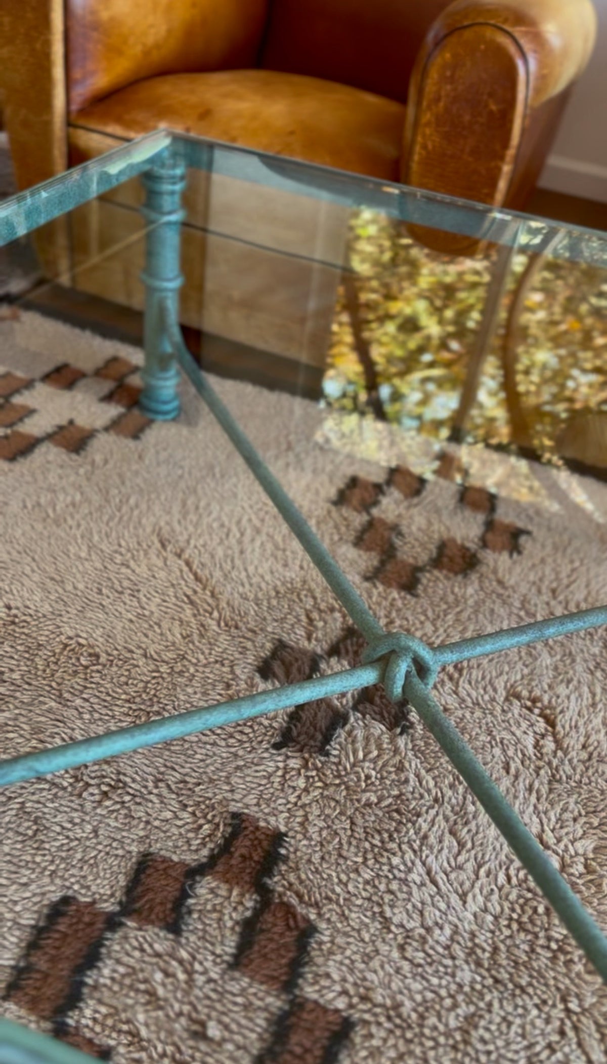Detail of the green verdigris patina on the hand-shaped metal coffee table base