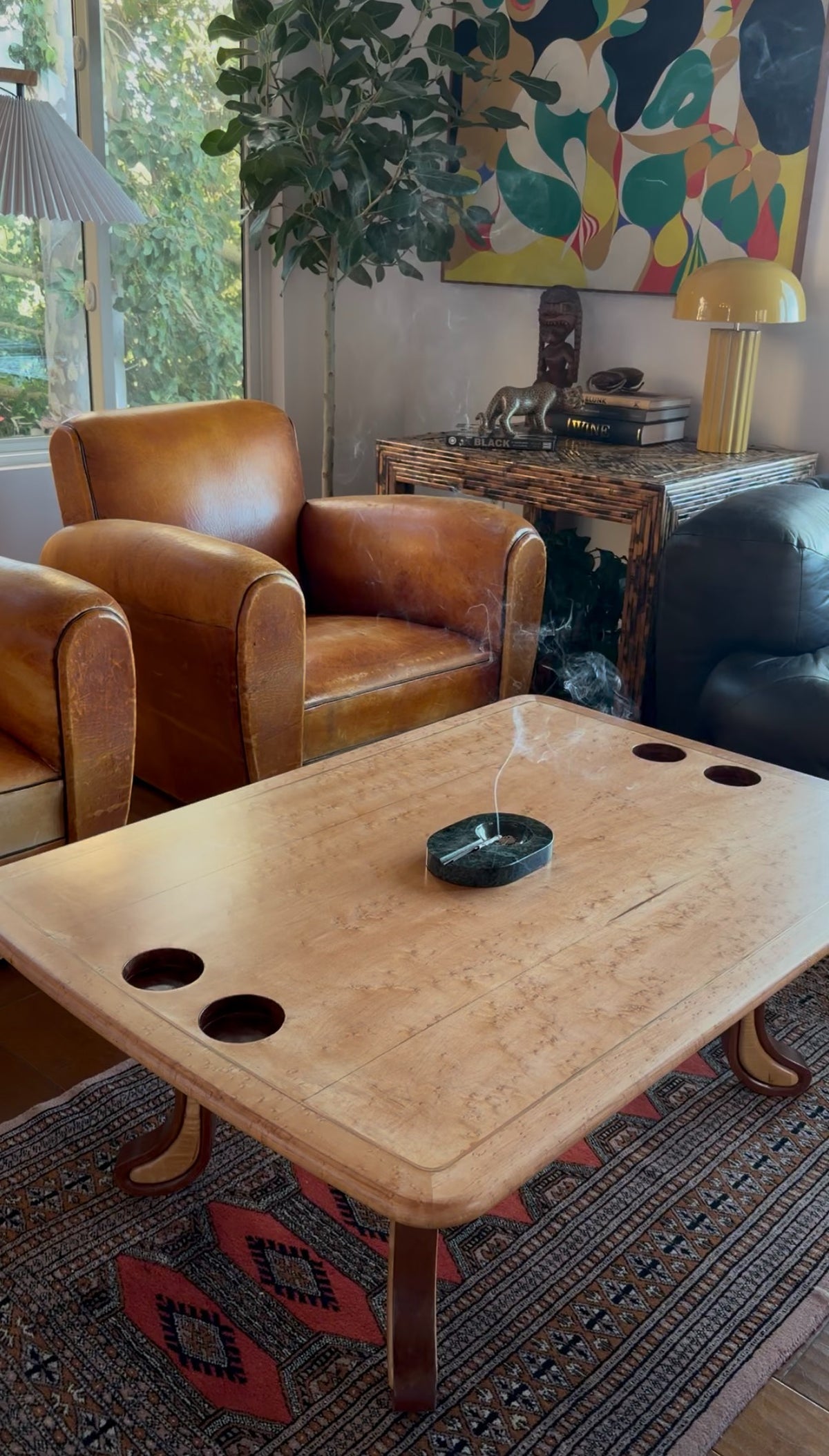 Two-tone hardwood grain across the top of the sculpted studio craft table