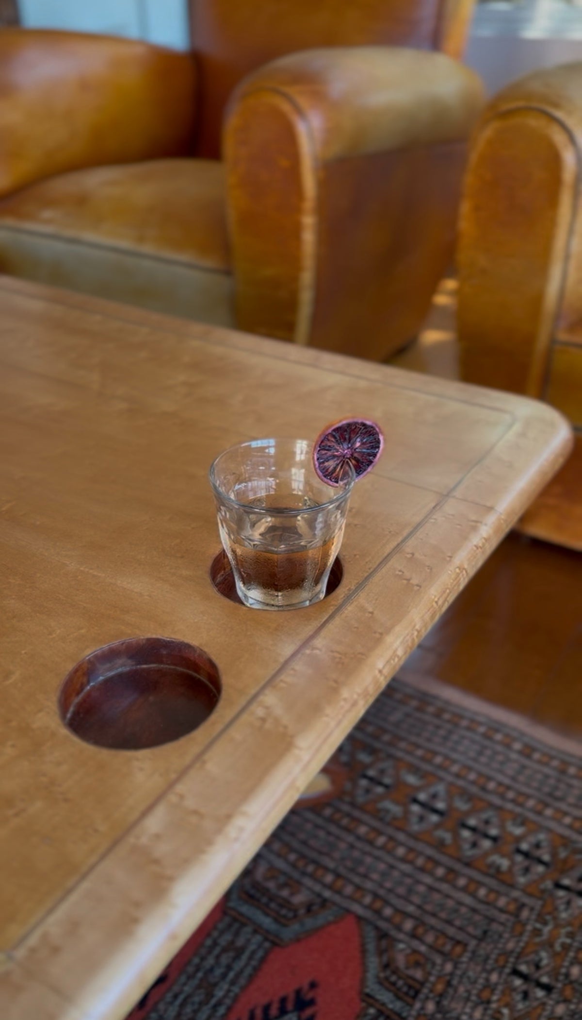 Built-in cup holders carved into the top of the studio craft coffee table