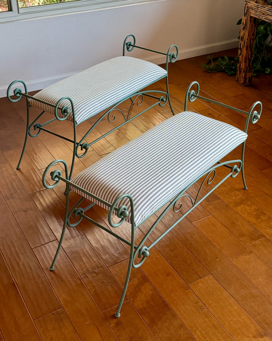 Pair of scrolled iron window benches in hand-painted green, upholstered in black and cream cotton ticking