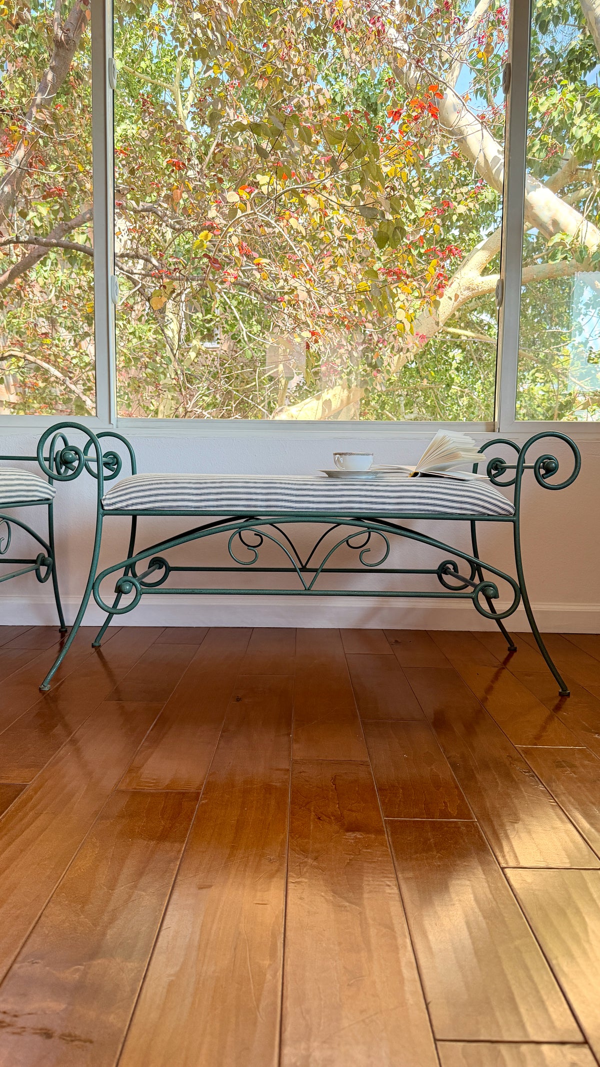 X-stretcher and splayed legs on the scrolled iron bench, hand-painted green finish