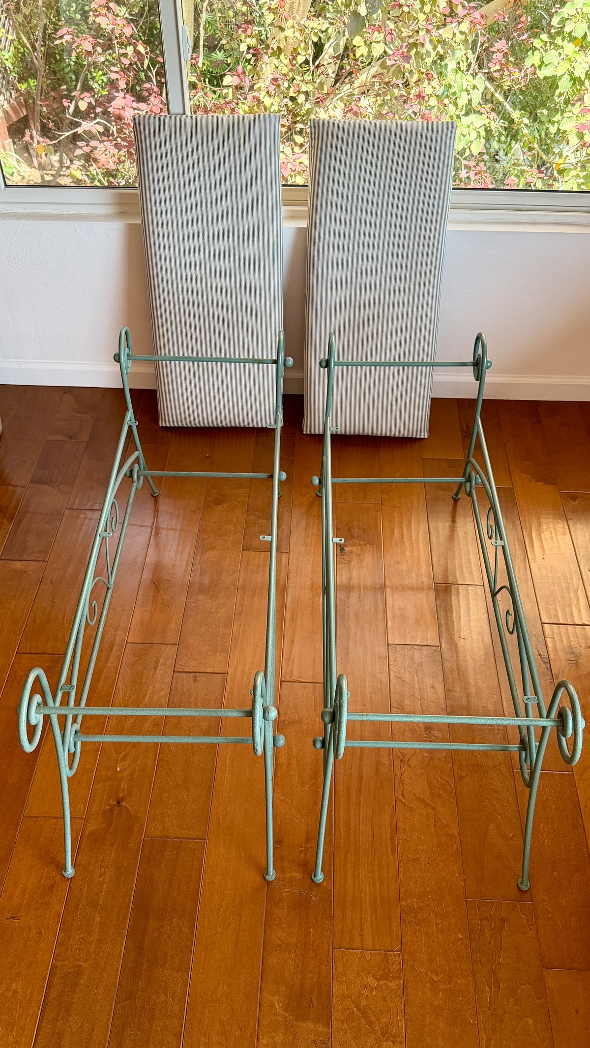 Pair of 45.5 inch scrolled iron window benches styled together in an interior