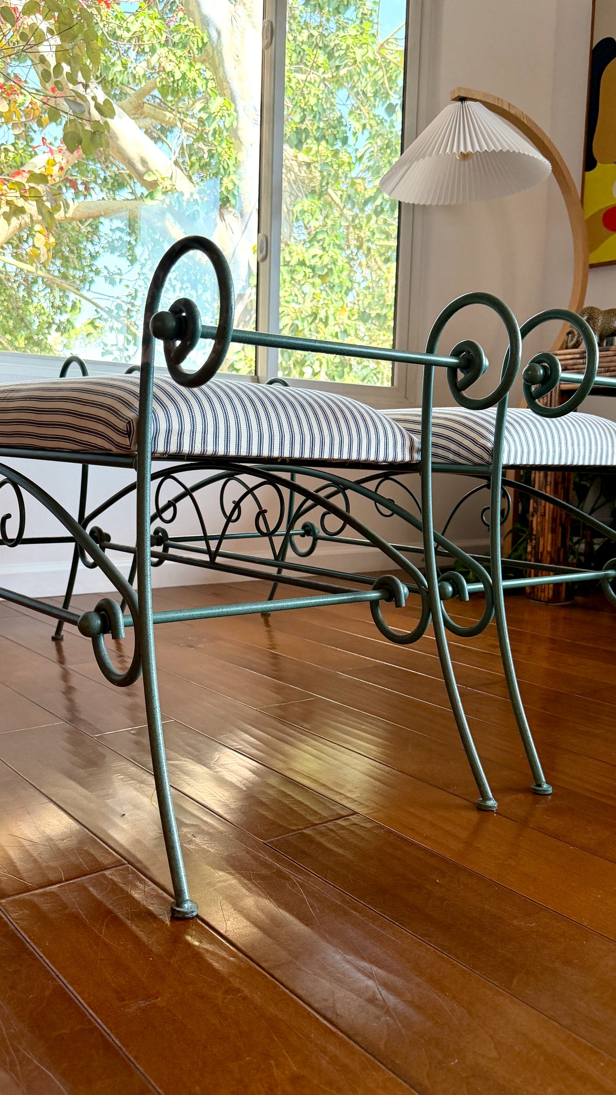 Black and cream cotton ticking upholstery on the iron window bench seat