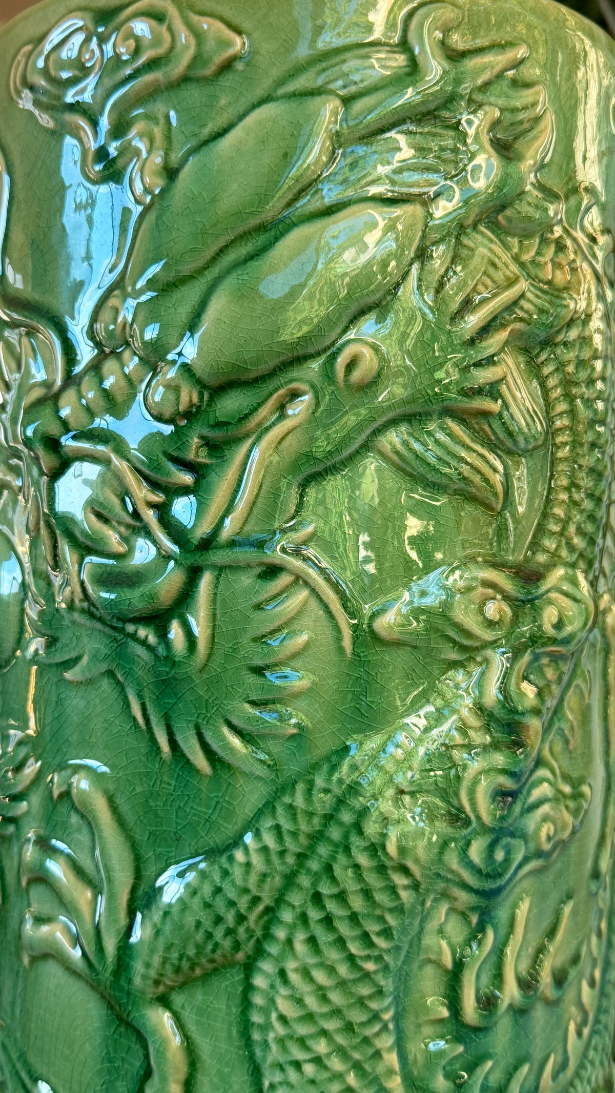 Dragon head modelled in relief on the green glazed stoneware umbrella stand