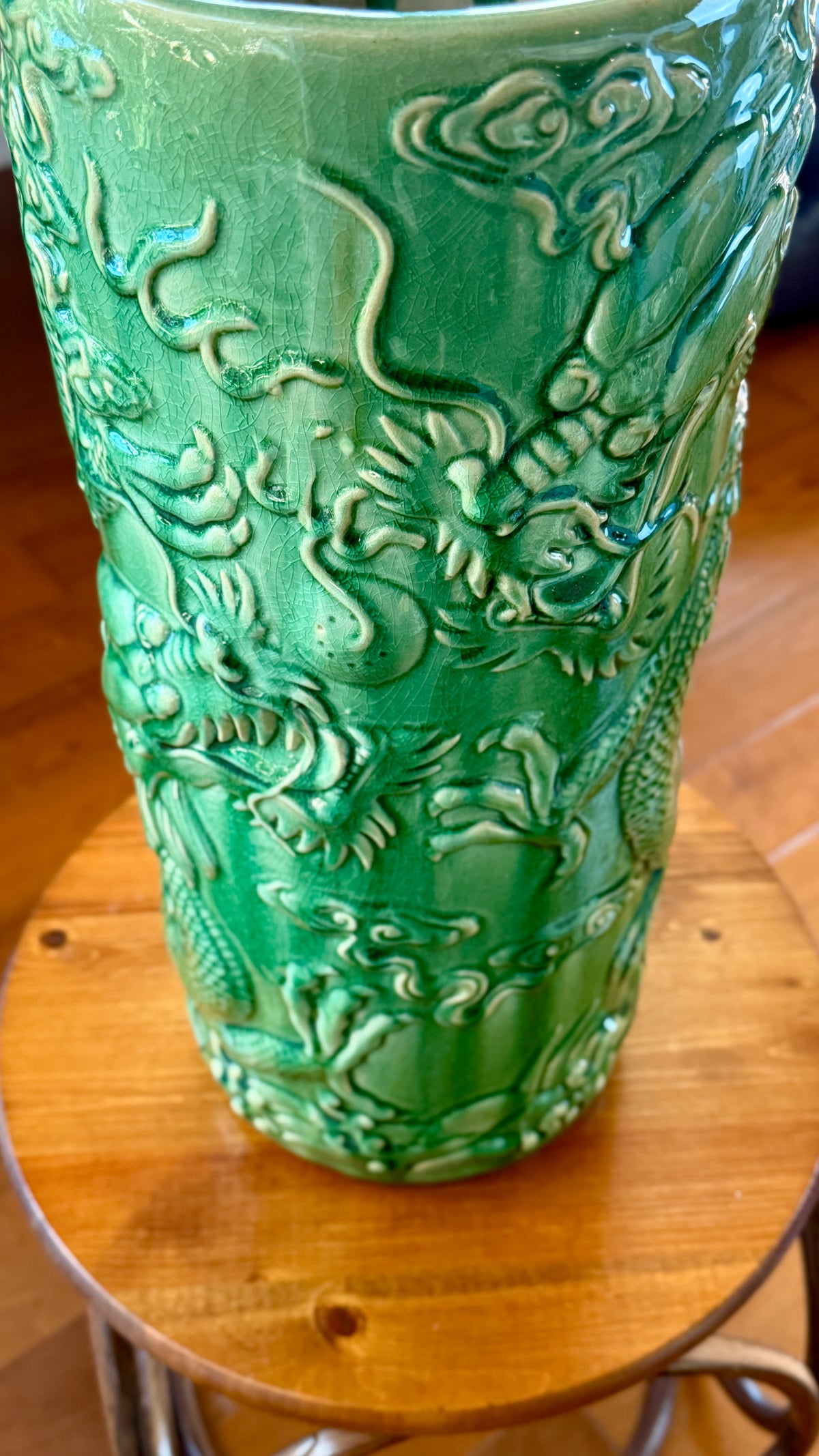 Detail of the green crackle glaze, showing the fine craquelure and glaze pooling in the relief