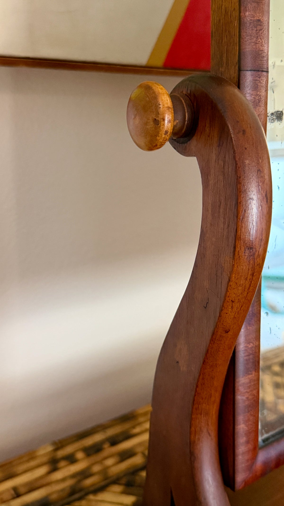 Heavy roll moulding across the plinth base of the mid-1800s mahogany dressing mirror