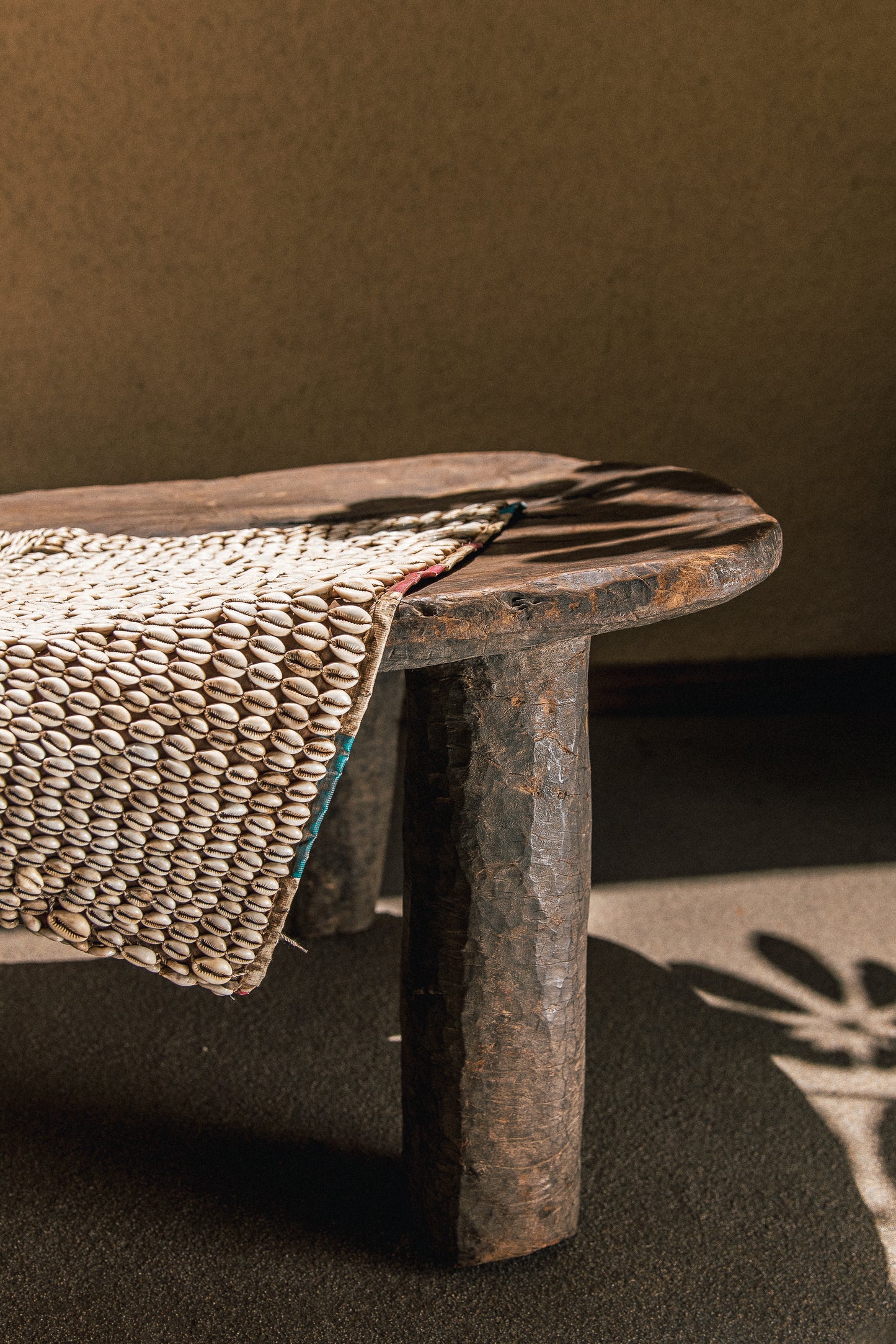 Hausa cowrie shell tapestry shown in a styled interior setting