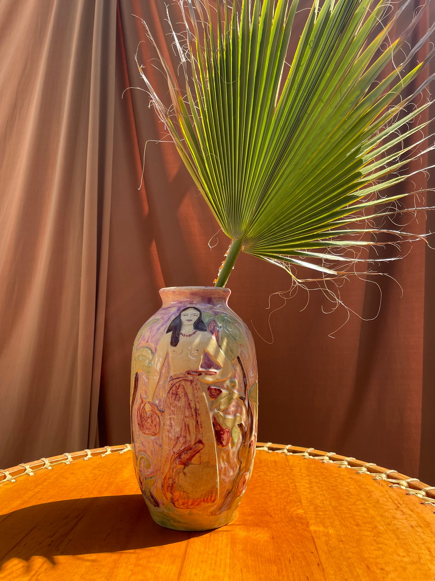 Close view of the glazed surface and etched linework on the ceramic vase