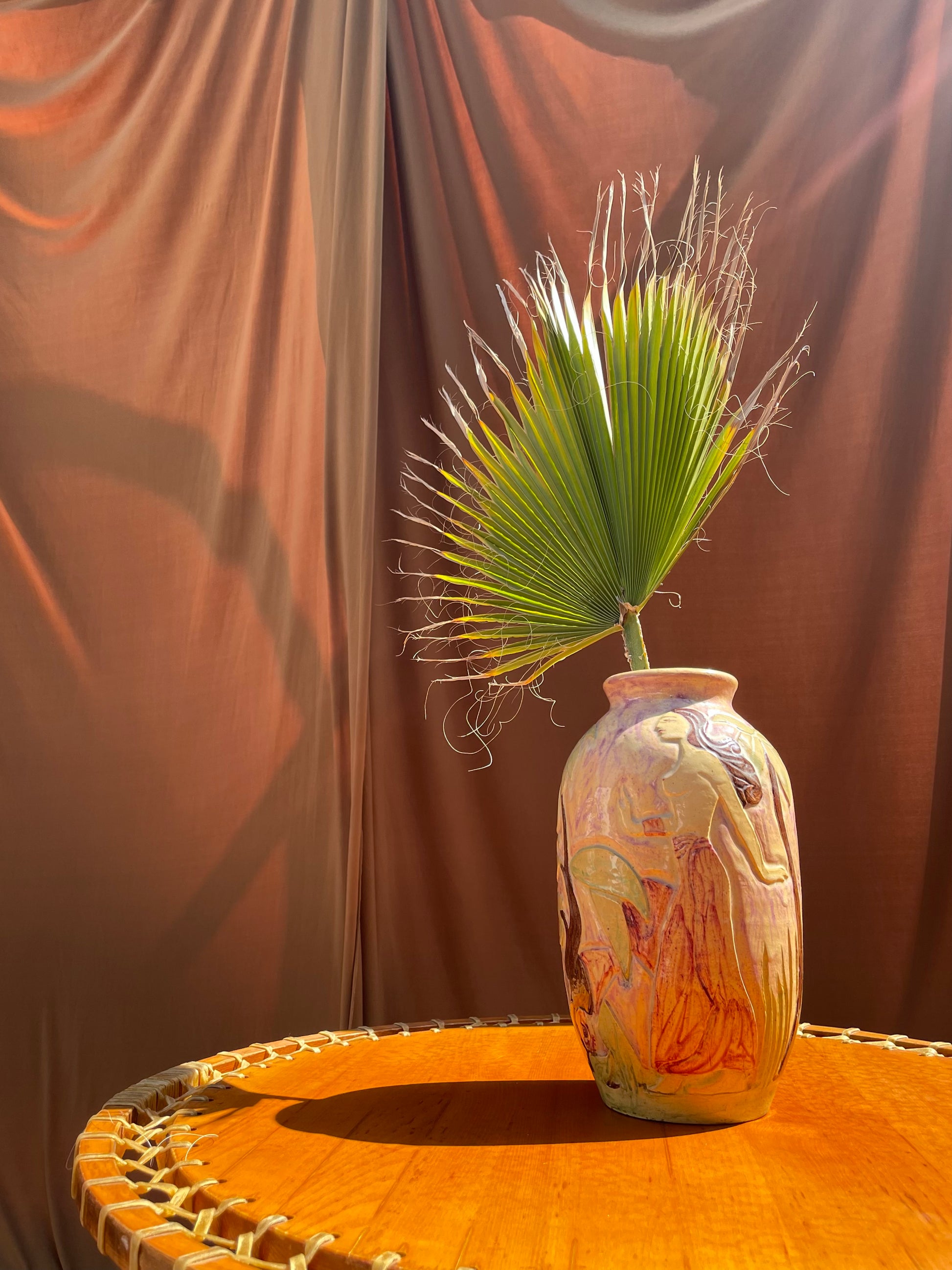 Vintage hand-painted ceramic vase with etched nude figures and palm fronds