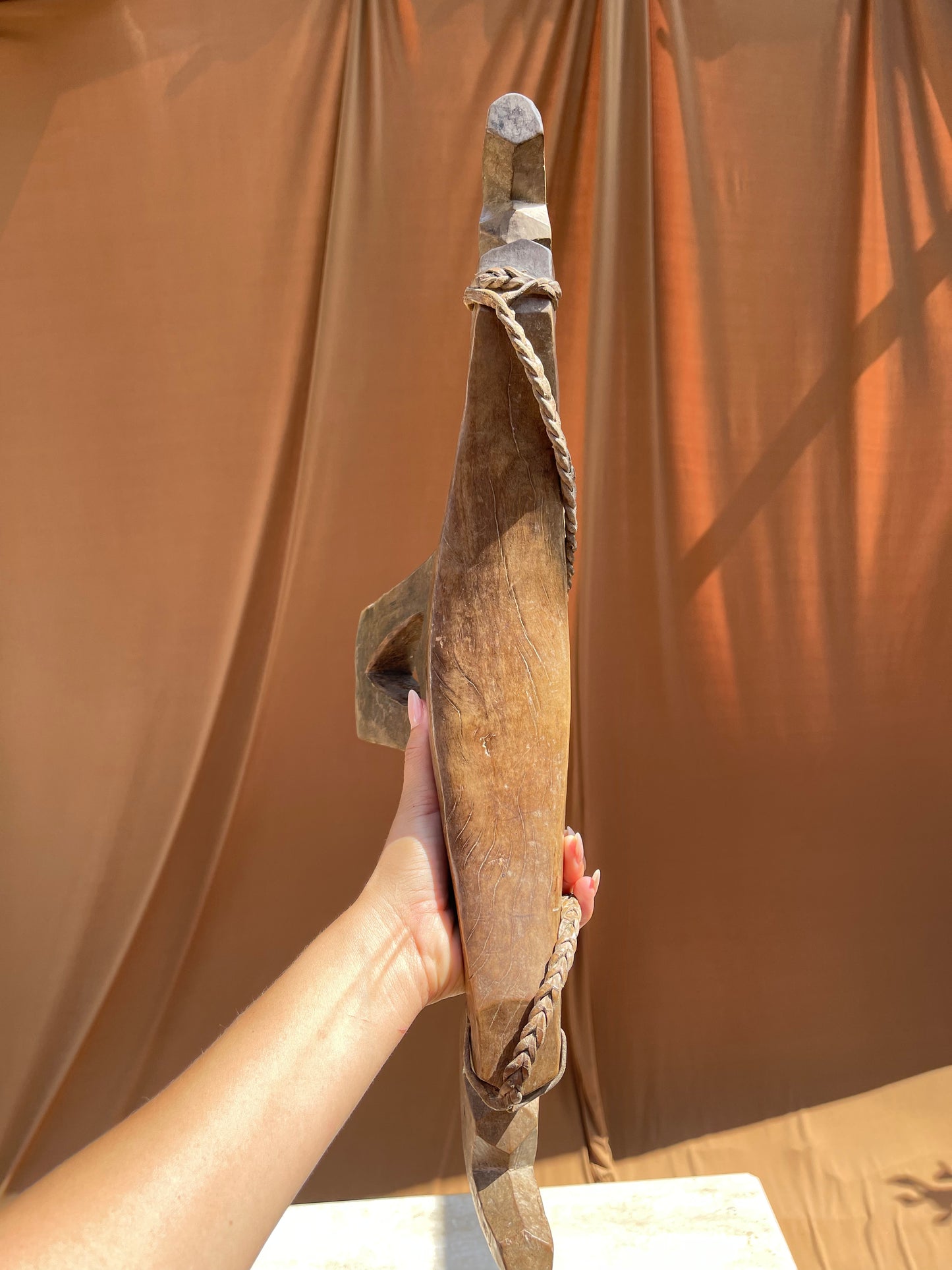 Side profile of the hand-carved Lobi stool from Burkina Faso