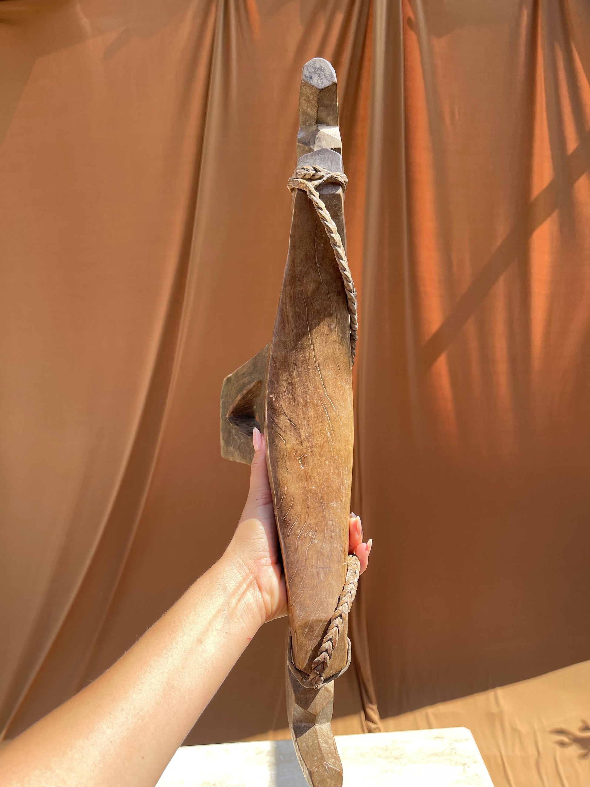 Side profile of the hand-carved Lobi stool from Burkina Faso