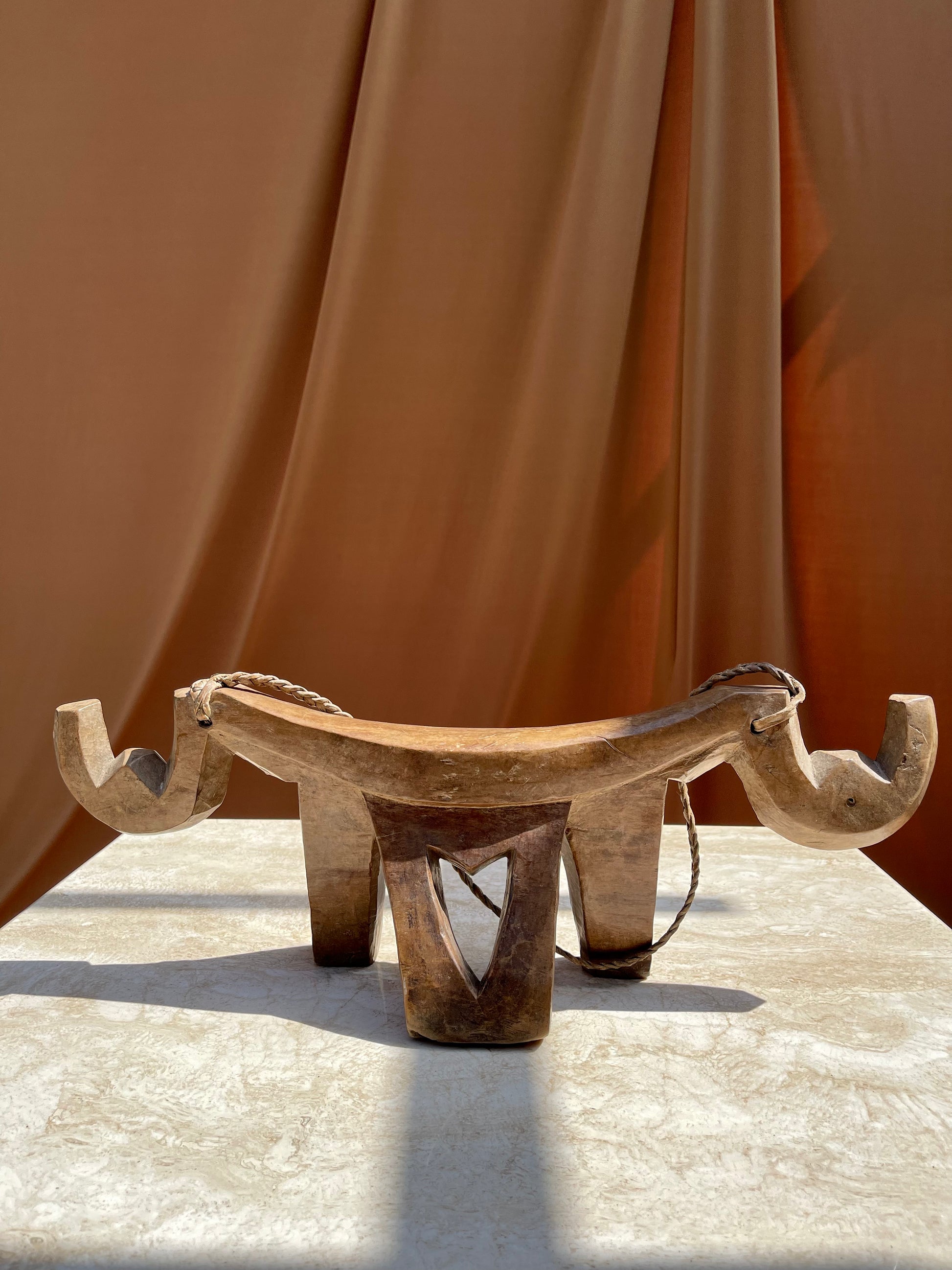 Antique hand-carved Lobi stool from Burkina Faso with braided leather carrying cord