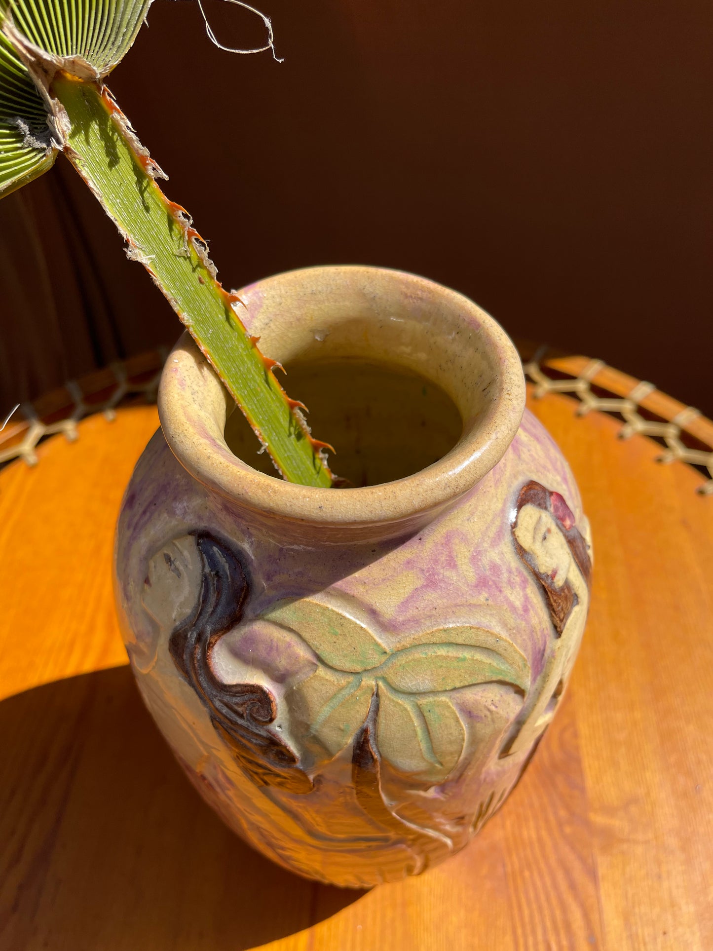 Vintage nude palm ceramic vase shown in a styled interior setting